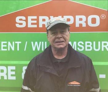 Tommy standing in front of Servpro vehicle