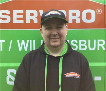 Charlie standing in front of a Servpro Vehicle