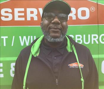 Rickey standing in front of a servpro truck